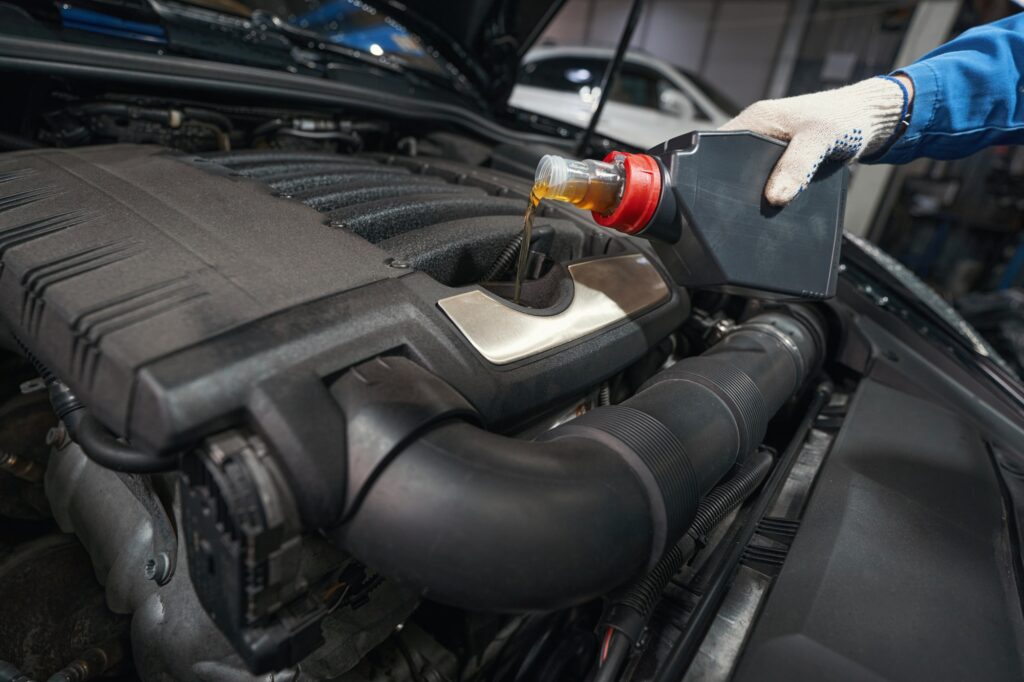 Man performing car maintenance at service station