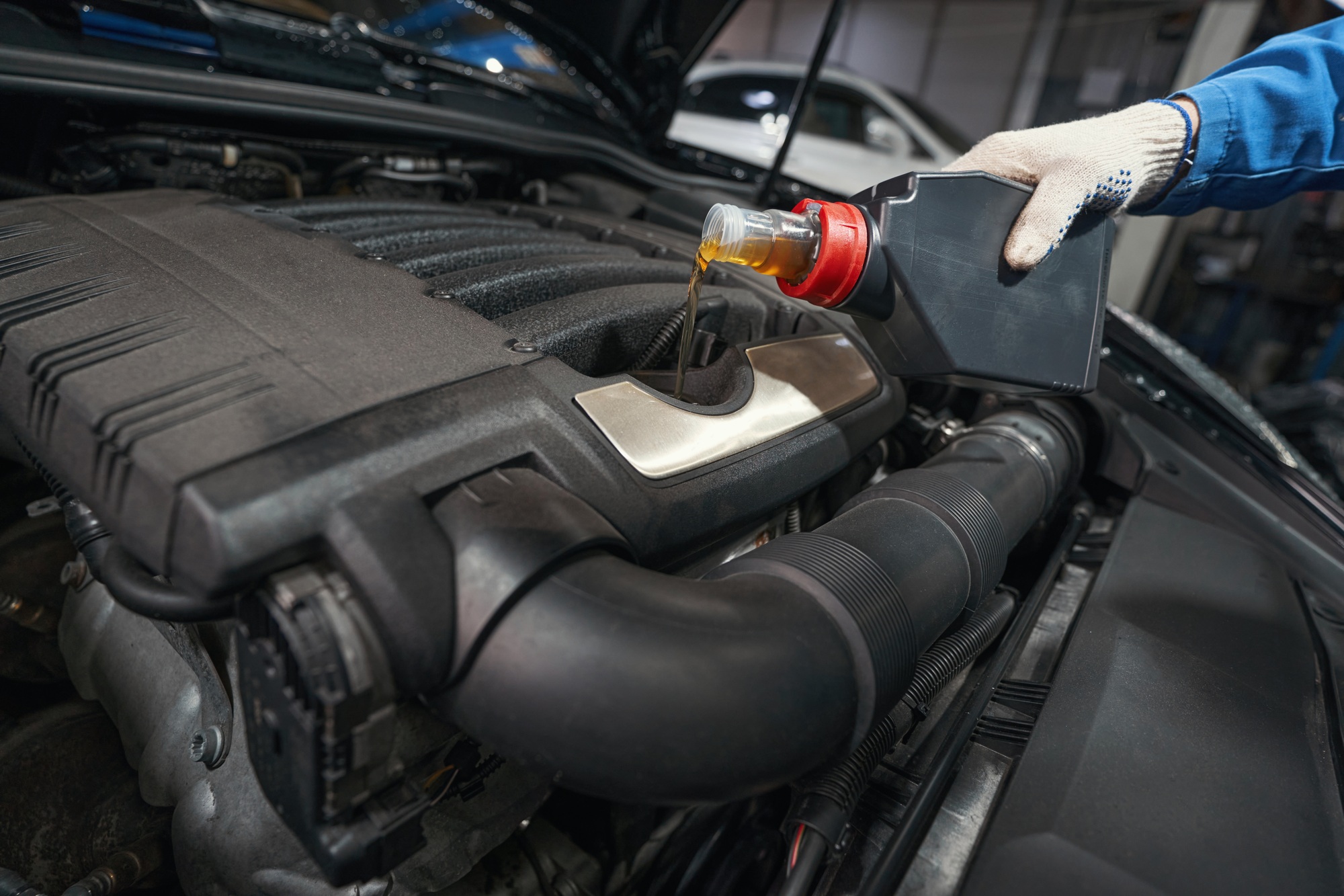 Man performing car maintenance at service station